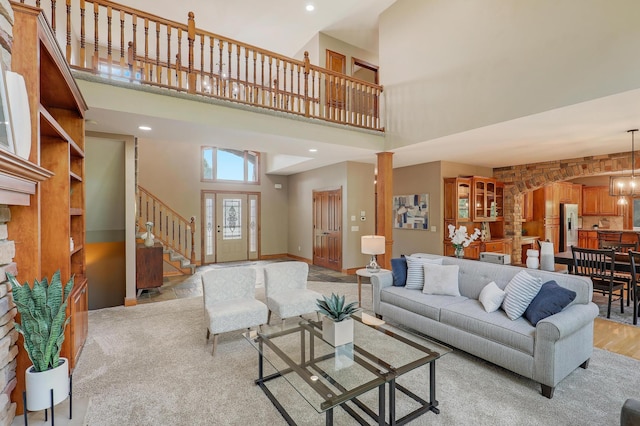 904 Ridgecrest Dr, Carver, MN 55315 - living area with a high ceiling, stairs, and light carpet