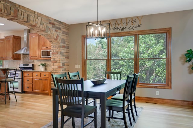 904 Ridgecrest Dr, Carver, MN 55315 - dining space with light wood-style floors and a chandelier