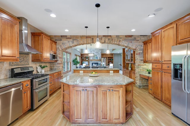 904 Ridgecrest Dr, Carver, MN 55315 - kitchen featuring stainless steel appliances, wall chimney exhaust hood, light wood-type flooring, a center island, and recessed lighting