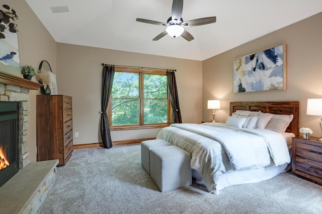 904 Ridgecrest Dr, Carver, MN 55315 - bedroom with light colored carpet, a stone fireplace, and a ceiling fan