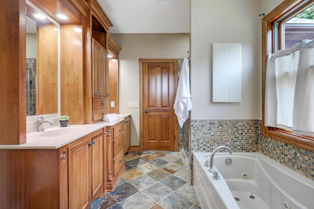 904 Ridgecrest Dr, Carver, MN 55315 - bathroom with vanity, a tub with jets, and stone finish flooring