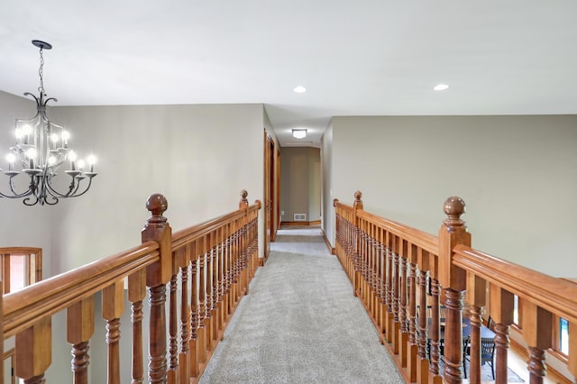 904 Ridgecrest Dr, Carver, MN 55315 - hallway with an upstairs landing, a chandelier, light colored carpet, and recessed lighting