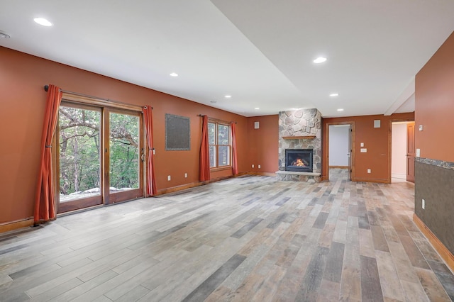 904 Ridgecrest Dr, Carver, MN 55315 - unfurnished living room with light wood-type flooring, a fireplace, and recessed lighting