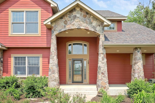 904 Ridgecrest Dr, Carver, MN 55315 - property entrance with stone siding, roof with shingles, and a porch