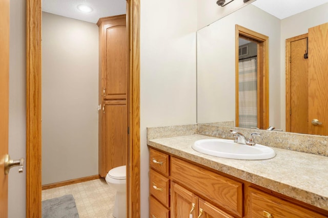 2745 Maplewood Cir, Monticello, MN 55362 - bathroom with toilet, vanity, tile patterned floors, and baseboards
