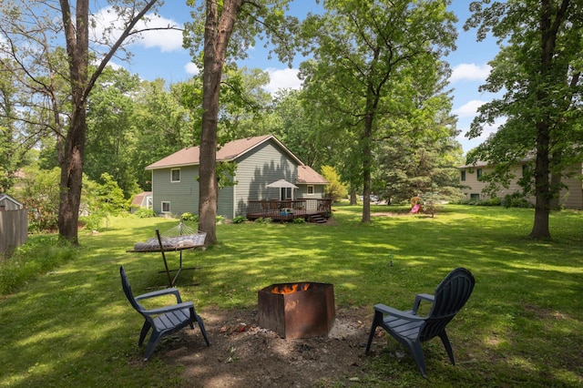 2745 Maplewood Cir, Monticello, MN 55362 - view of green lawn featuring a deck and view of wooded area