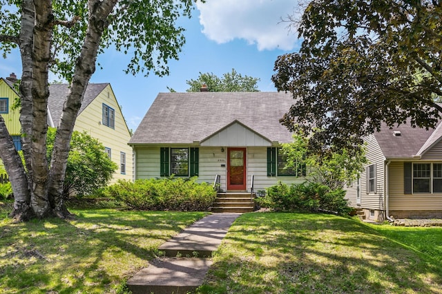 5422 Vincent Ave S, Minneapolis, MN 55410 - view of front of home with a front yard, a chimney, and a shingled roof