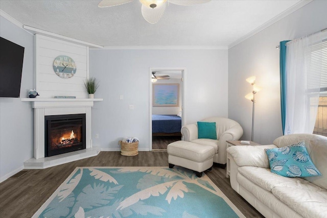 311 Franklin St, Lake City, MN 55041 - living room with a ceiling fan, wood finished floors, ornamental molding, a fireplace, and baseboards