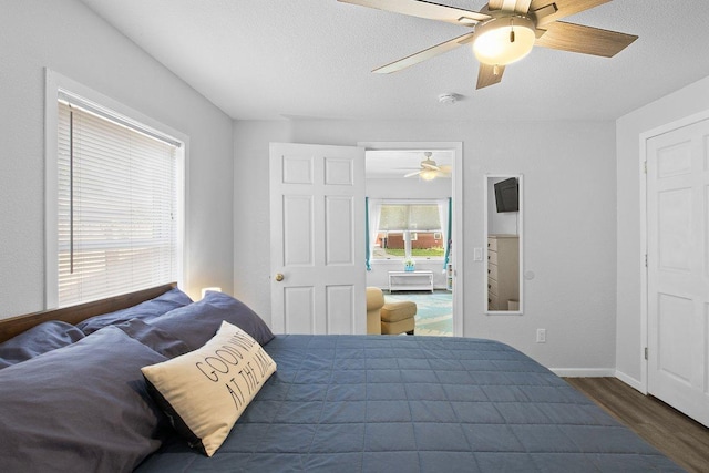 311 Franklin St, Lake City, MN 55041 - bedroom featuring wood finished floors, a textured ceiling, ceiling fan, and baseboards