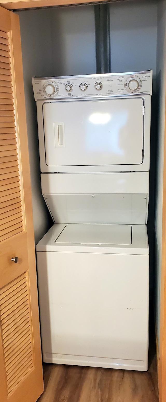 1805 3rd Ave S Unit 102, Minneapolis, MN 55404 - washroom featuring estacked washer and dryer and wood finished floors