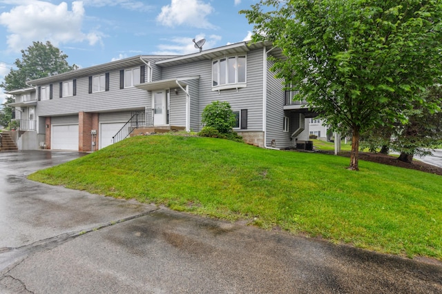14737 Endicott Way, Apple Valley, MN 55124 - raised ranch with asphalt driveway, an attached garage, a front yard, and cooling unit