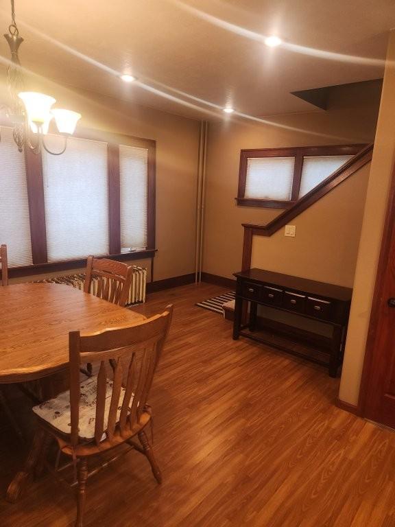 313 2nd St, Hills, MN 56138 - dining room with wood finished floors, baseboards, and a chandelier