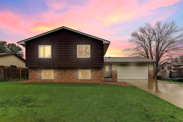 8317 Penn Ave N, Brooklyn Park, MN 55444 - split level home with brick siding, an attached garage, and concrete driveway