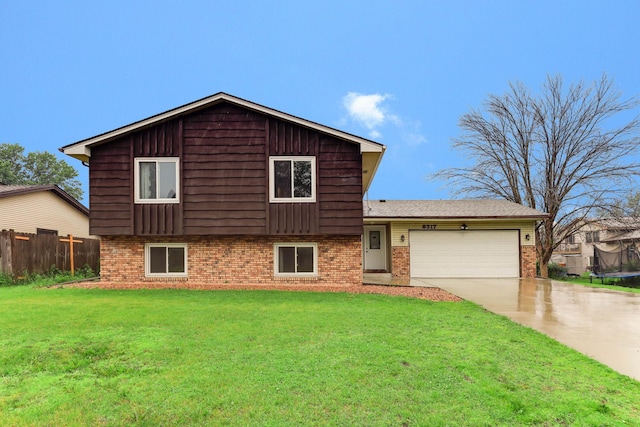 8317 Penn Ave N, Brooklyn Park, MN 55444 - view of front facade with brick siding, a garage, concrete driveway, and a trampoline
