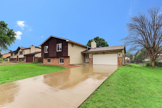 8317 Penn Ave N, Brooklyn Park, MN 55444 - view of front of home with concrete driveway, an attached garage, brick siding, a front yard, and a chimney