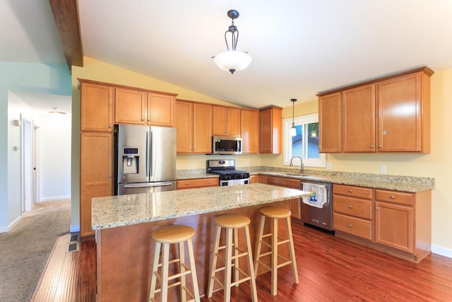 8317 Penn Ave N, Brooklyn Park, MN 55444 - kitchen with stainless steel appliances, vaulted ceiling, a sink, a kitchen island, and dark wood finished floors