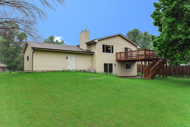 8317 Penn Ave N, Brooklyn Park, MN 55444 - rear view of property with a wooden deck, stairs, a chimney, a yard, and roof with shingles