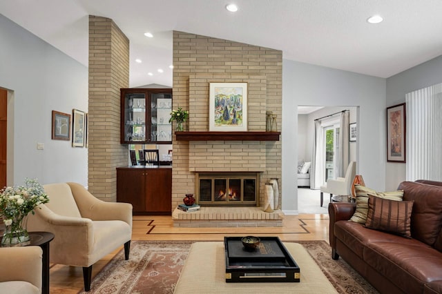 2367 Apache Ct, Mendota Heights, MN 55120 - living area featuring vaulted ceiling, wood finished floors, a fireplace, and recessed lighting
