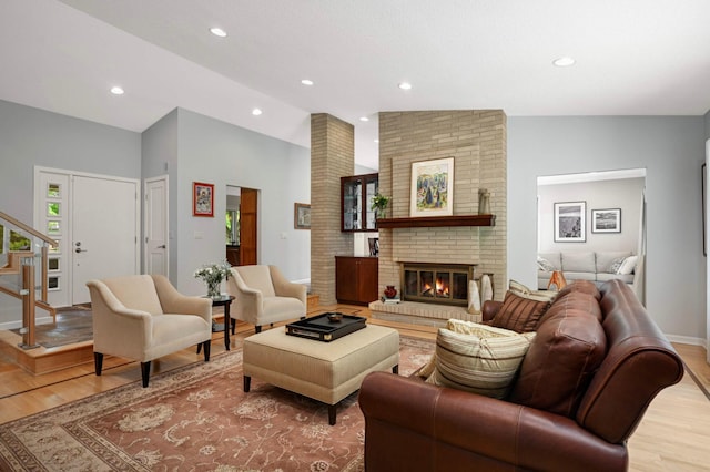 2367 Apache Ct, Mendota Heights, MN 55120 - living room with wood finished floors, a fireplace, recessed lighting, stairway, and lofted ceiling