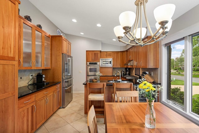 2367 Apache Ct, Mendota Heights, MN 55120 - kitchen with appliances with stainless steel finishes, dark countertops, backsplash, under cabinet range hood, and a chandelier