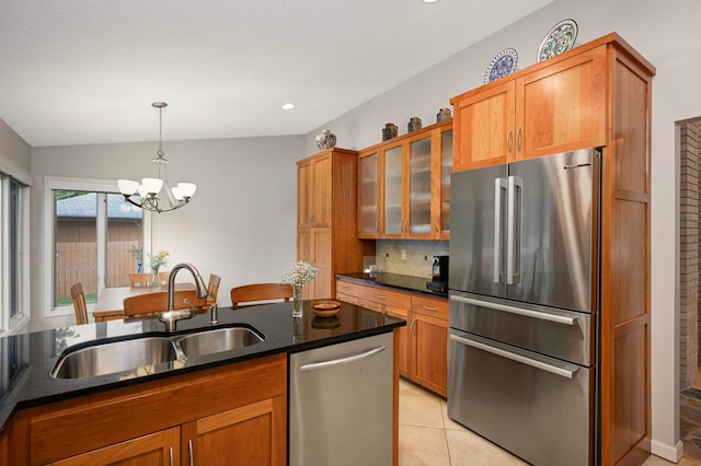 2367 Apache Ct, Mendota Heights, MN 55120 - kitchen featuring stainless steel appliances, a chandelier, brown cabinets, tasteful backsplash, and glass insert cabinets