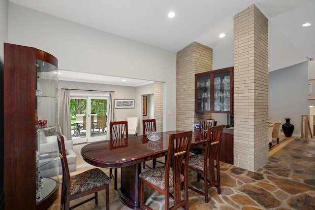 2367 Apache Ct, Mendota Heights, MN 55120 - dining area featuring decorative columns, stone floors, high vaulted ceiling, and recessed lighting
