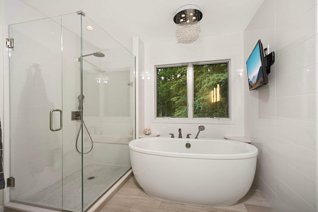 2367 Apache Ct, Mendota Heights, MN 55120 - bathroom featuring a freestanding tub and a shower stall