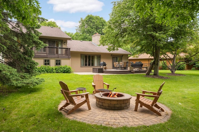 2367 Apache Ct, Mendota Heights, MN 55120 - rear view of house with an outdoor fire pit, stucco siding, a yard, a chimney, and a patio area