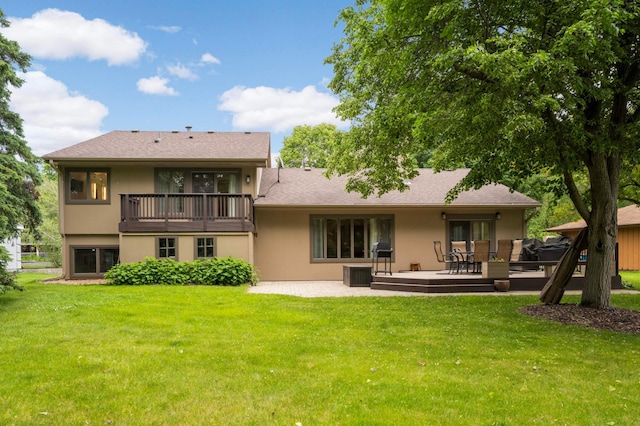 2367 Apache Ct, Mendota Heights, MN 55120 - rear view of property featuring stucco siding, a yard, a balcony, a patio area, and a deck