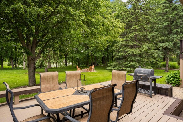 2367 Apache Ct, Mendota Heights, MN 55120 - wooden deck with outdoor dining area, a yard, grilling area, and view of wooded area