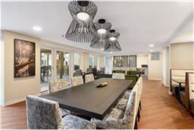 433 7th St Unit 1603, Minneapolis, MN 55415 - dining space featuring wood finished floors, a chandelier, and recessed lighting