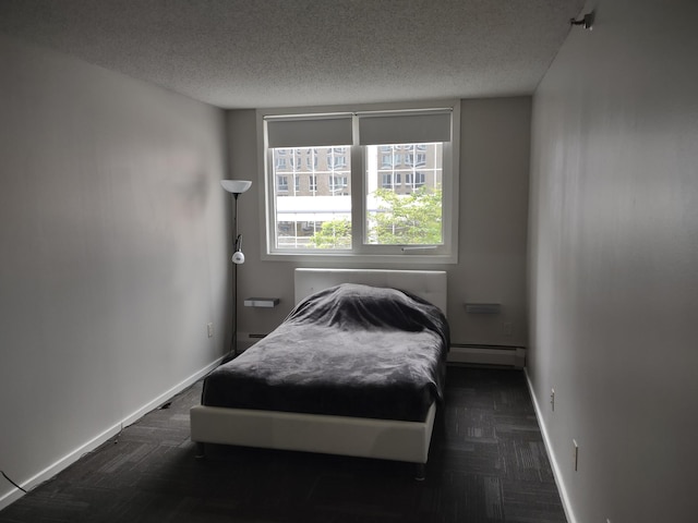 433 7th St Unit 1603, Minneapolis, MN 55415 - bedroom featuring a baseboard radiator and a textured ceiling