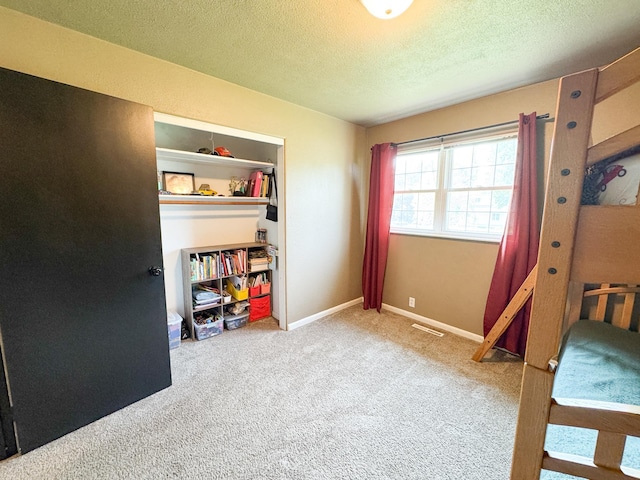 810 Division St, Elbow Lake, MN 56531 - bedroom featuring a textured ceiling, carpet, and baseboards