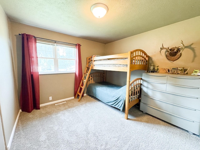 810 Division St, Elbow Lake, MN 56531 - carpeted bedroom featuring a textured ceiling and baseboards