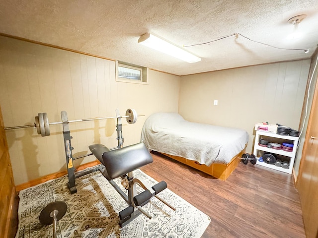 810 Division St, Elbow Lake, MN 56531 - bedroom featuring wood finished floors, a textured ceiling, and wooden walls