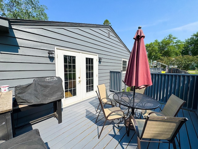 810 Division St, Elbow Lake, MN 56531 - wooden deck with french doors and outdoor dining space
