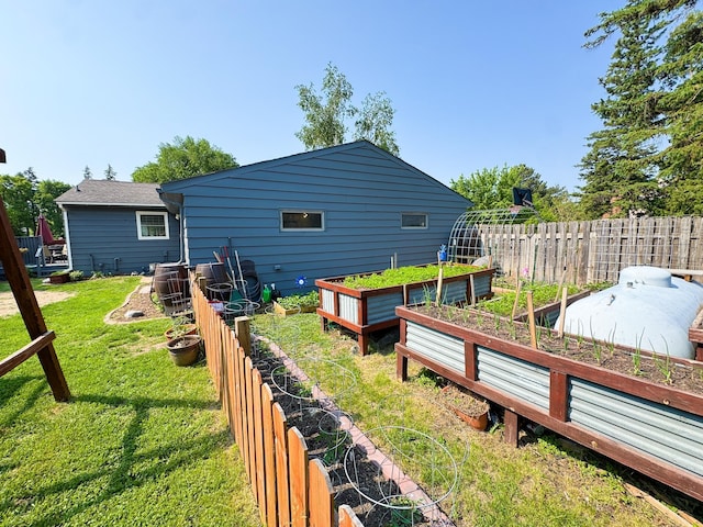 810 Division St, Elbow Lake, MN 56531 - back of house with a vegetable garden
