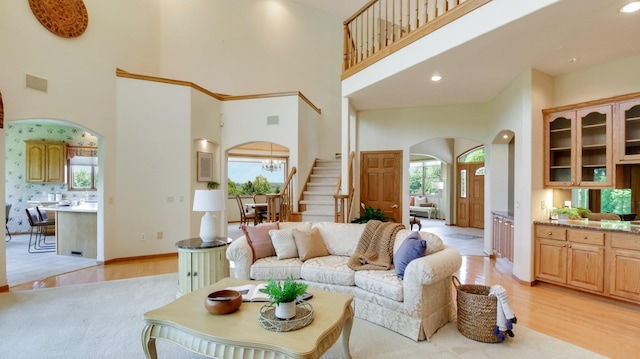 E5110 Interlachen Blvd, Pleasant Valley Twp, WI 54738 - living room featuring arched walkways, a high ceiling, stairs, light wood finished floors, and recessed lighting