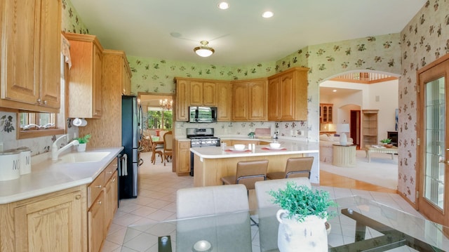 E5110 Interlachen Blvd, Pleasant Valley Twp, WI 54738 - kitchen with wallpapered walls, appliances with stainless steel finishes, a sink, light countertops, and light tile patterned floors