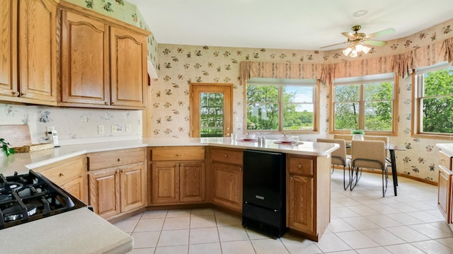 E5110 Interlachen Blvd, Pleasant Valley Twp, WI 54738 - kitchen with wallpapered walls, light countertops, a peninsula, ceiling fan, and light tile patterned flooring