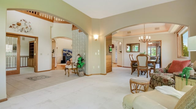 E5110 Interlachen Blvd, Pleasant Valley Twp, WI 54738 - living area with a chandelier, arched walkways, baseboards, and carpet