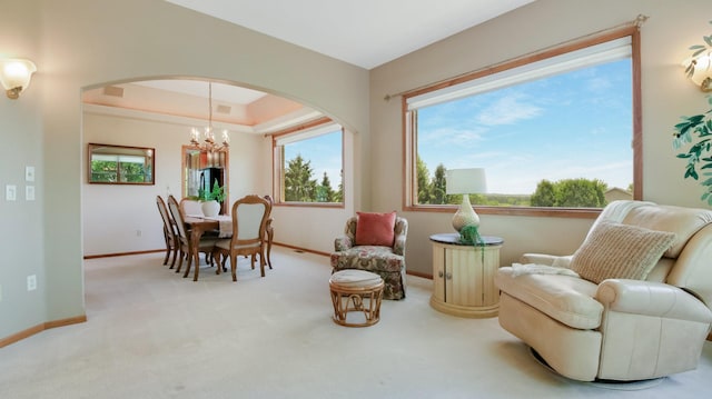 E5110 Interlachen Blvd, Pleasant Valley Twp, WI 54738 - sitting room with carpet flooring, arched walkways, a chandelier, baseboards, and a raised ceiling