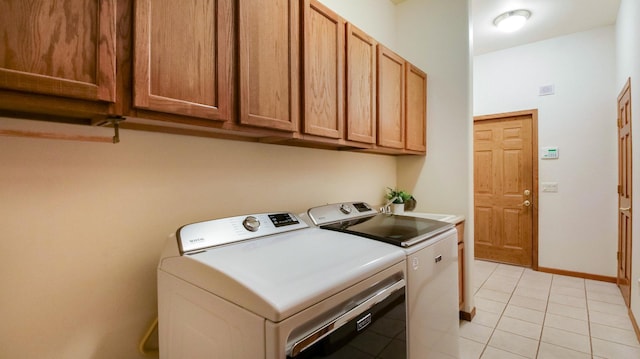 E5110 Interlachen Blvd, Pleasant Valley Twp, WI 54738 - washroom with washer and dryer, cabinet space, and light tile patterned floors