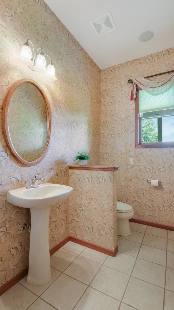 E5110 Interlachen Blvd, Pleasant Valley Twp, WI 54738 - bathroom featuring tile patterned floors, toilet, and baseboards
