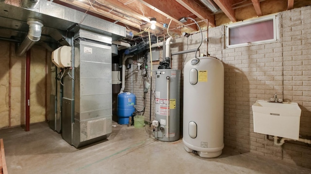 E5110 Interlachen Blvd, Pleasant Valley Twp, WI 54738 - unfinished below grade area with water heater, a water pressure tank, a sink, heating unit, and brick wall