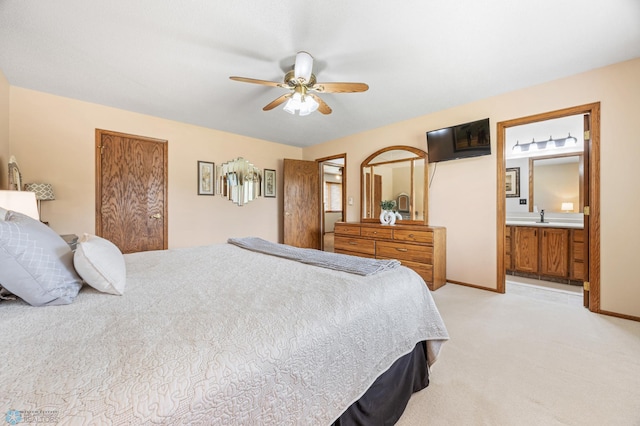 5701 33rd St S, Fargo, ND 58104 - bedroom with light colored carpet, a sink, a ceiling fan, and ensuite bathroom