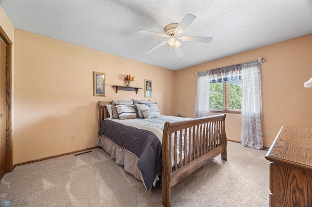 5701 33rd St S, Fargo, ND 58104 - bedroom with carpet flooring, baseboards, a textured ceiling, and a ceiling fan