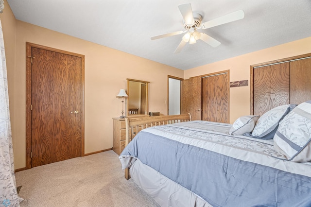 5701 33rd St S, Fargo, ND 58104 - bedroom with two closets, carpet flooring, a ceiling fan, and baseboards
