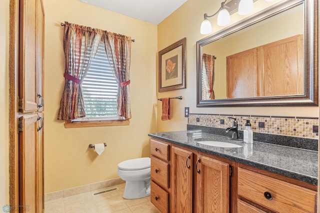 5701 33rd St S, Fargo, ND 58104 - full bath featuring vanity, toilet, tile patterned flooring, and baseboards
