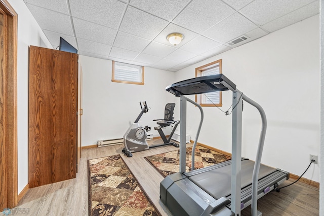 5701 33rd St S, Fargo, ND 58104 - exercise room featuring baseboards, wood finished floors, and a drop ceiling